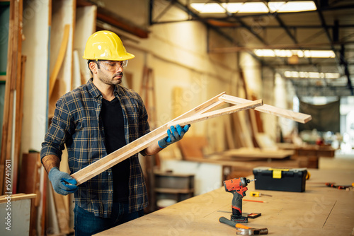 Carpenter man attend to making masterpiece woodworks handcrafted furniture fine measure in wood workshop.