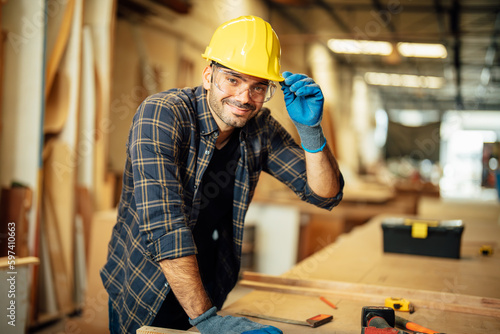 Carpenter man attend to making masterpiece woodworks handcrafted furniture fine measure in wood workshop.