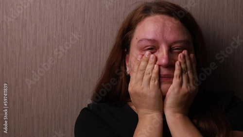 Broken woman hysterically cry and scream grabbing head near room wall. Tears rolling down cheeks. Splash out emotions, weep bitterly. Emotional breakdown, mental health crisis, hysterics.