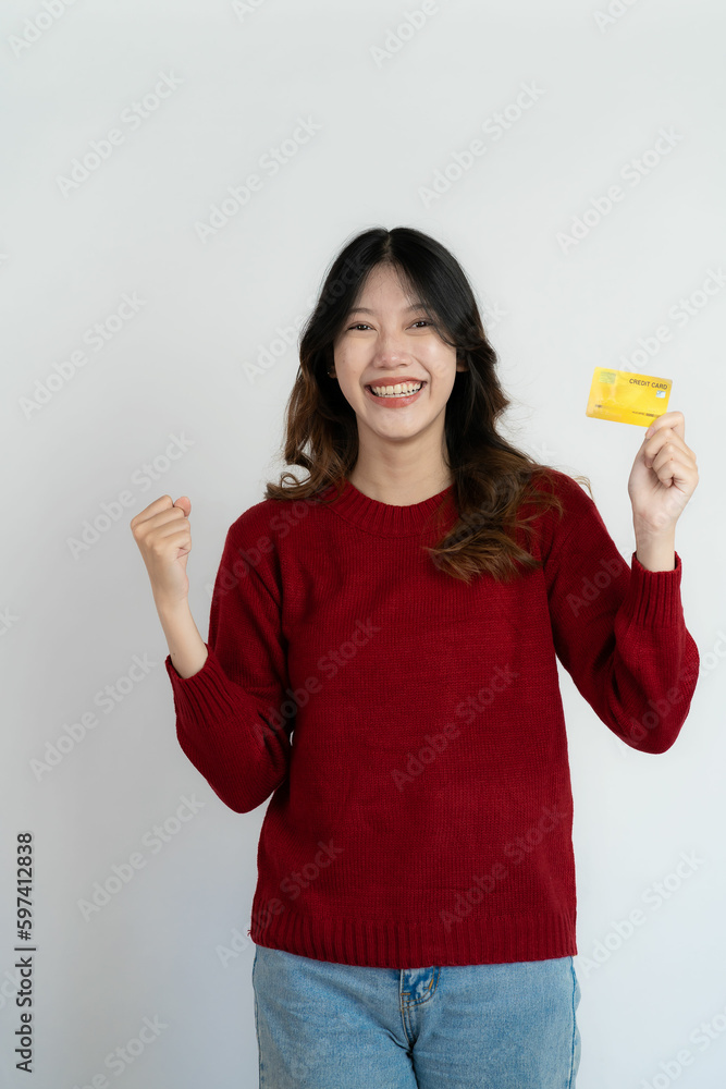 Asian woman holding credit card on white background, happy female smiling and showing credit card for paying online business isolated on background Asian woman holding credit card on white background, happy female smiling and showing credit card for paying online business isolated on background