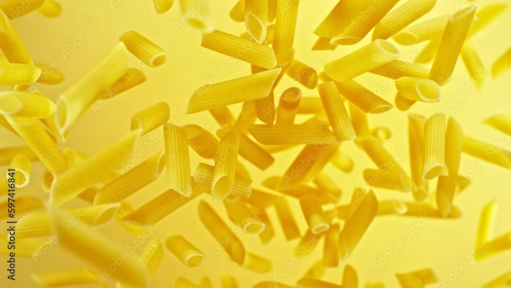 Super slow motion of flying uncooked Italian pasta penne. Filmed on high speed cinema camera, 1000 fps, placed on high speed cine bot, following the object. Super slow motion of flying uncooked Italian pasta penne. Filmed on high speed cinema camera, 1000 fps, placed on high speed cine bot, following the object.