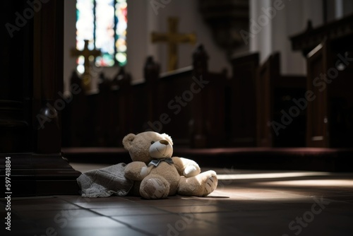 Fotografia, Obraz Concept of child abuse in church: teddy bear on the floor in cathedral