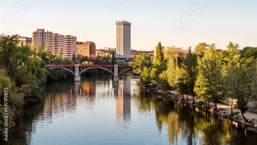 Urban landscape of the city of Valladolid in spring. River Pisuerga's waterfront as it flows through the capital of Valladolid. photo