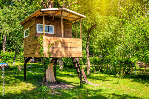 Tableau sur toile Handmade tree house in sunny garden