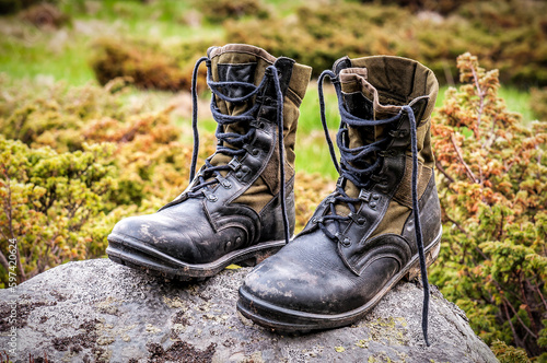 Military hiking boots on the stone