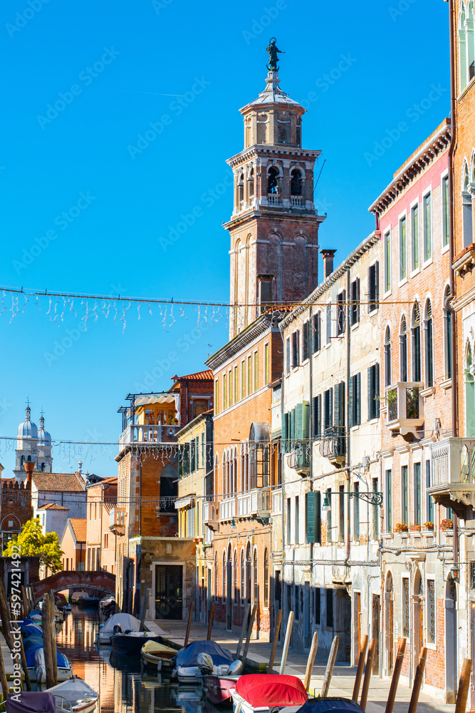 Fototapeta premium Narrow canals of Venice city with old traditional architecture, bridges and boats, Veneto, Italy. Tourism concept. Architecture and landmark of Venice. Cozy cityscape of Venice.