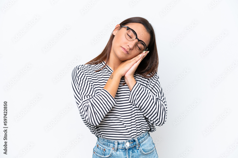 Young caucasian woman isolated on white background making sleep gesture in dorable expression Young caucasian woman isolated on white background making sleep gesture in dorable expression