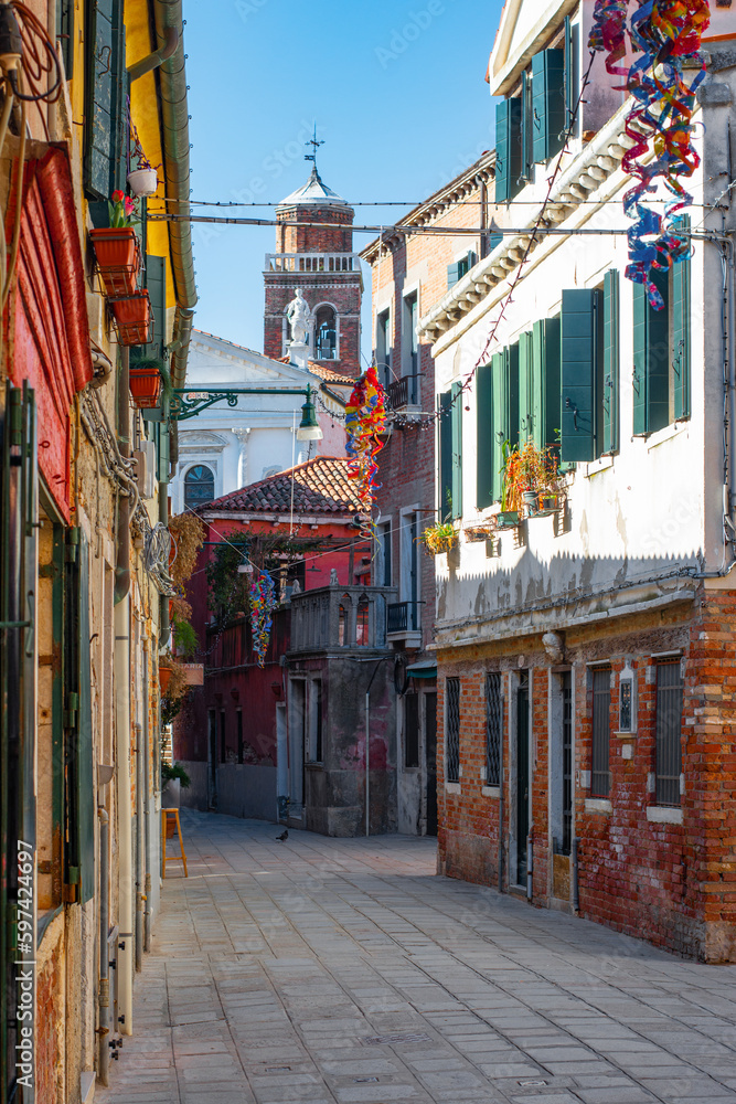 Fototapeta premium Cozy narrow streets of Venice city with old traditional architecture, Veneto, Italy. Tourism concept. Architecture and landmark of Venice. Cityscape of Venice.