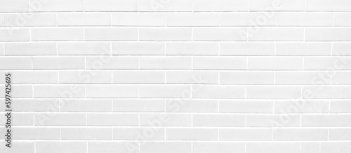 Brick wall painted with gray paint pastel bright tone texture background. Brickwork and stonework flooring interior with rock old pattern clean grid concrete uneven bricks design backdrop.