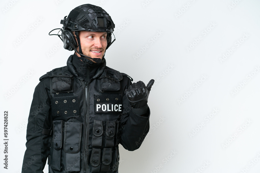 SWAT man over isolated white background pointing to the side to present a product SWAT man over isolated white background pointing to the side to present a product