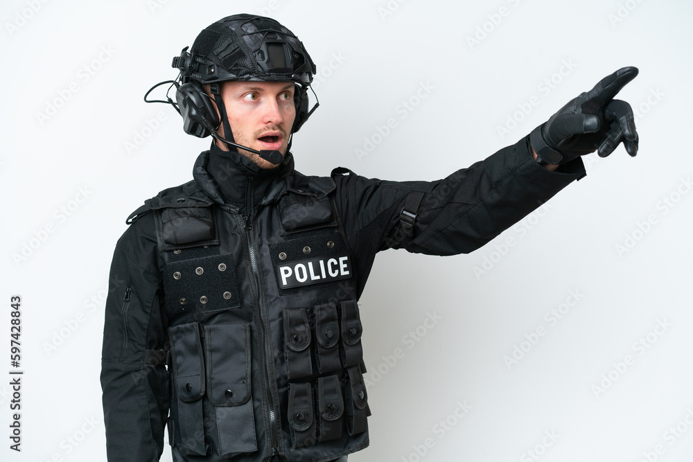 SWAT man over isolated white background pointing away SWAT man over isolated white background pointing away