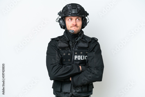 SWAT man over isolated white background making doubts gesture while lifting the shoulders