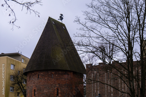 Round tower in the historic surrounding city wall of Slupsk, Poland. Witches tower - Baszta Czarownic in Slupsk. Sights of Poland. Old jail. Travel destination. Tourist attraction  photo