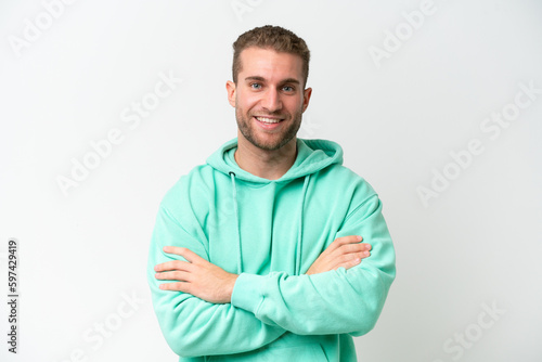 Young handsome caucasian man isolated on white background keeping the arms crossed in frontal position © luismolinero