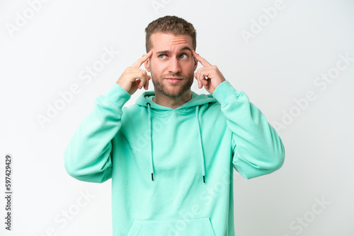 Young handsome caucasian man isolated on white background having doubts and thinking © luismolinero