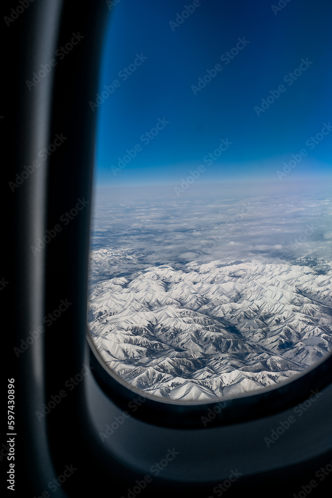 View from the airplane window. View from the window of an airplane during a flight in daylight at high altitude. View from the airplane window. View from the window of an airplane during a flight in daylight at high altitude.
