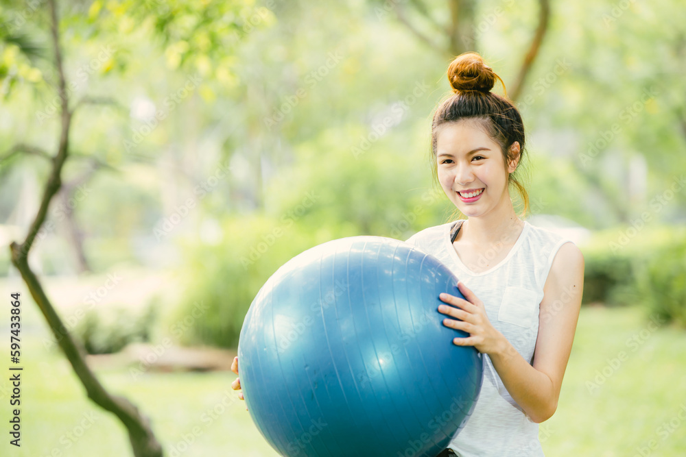 beautiful asian happy woman play enjoy fun with fit ball exercise at park outdoor slim and healthy girl workout activity. beautiful asian happy woman play enjoy fun with fit ball exercise at park outdoor slim and healthy girl workout activity.