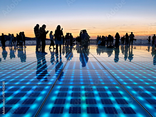 silhouette people standing on solar panel Greeting to the Sun located in Zadar, Croatia