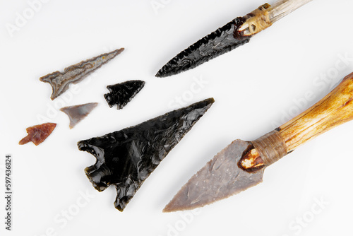 Fotografie Stone Age Tools on white Background - Stone Age Knives and Obsidian Arrows
