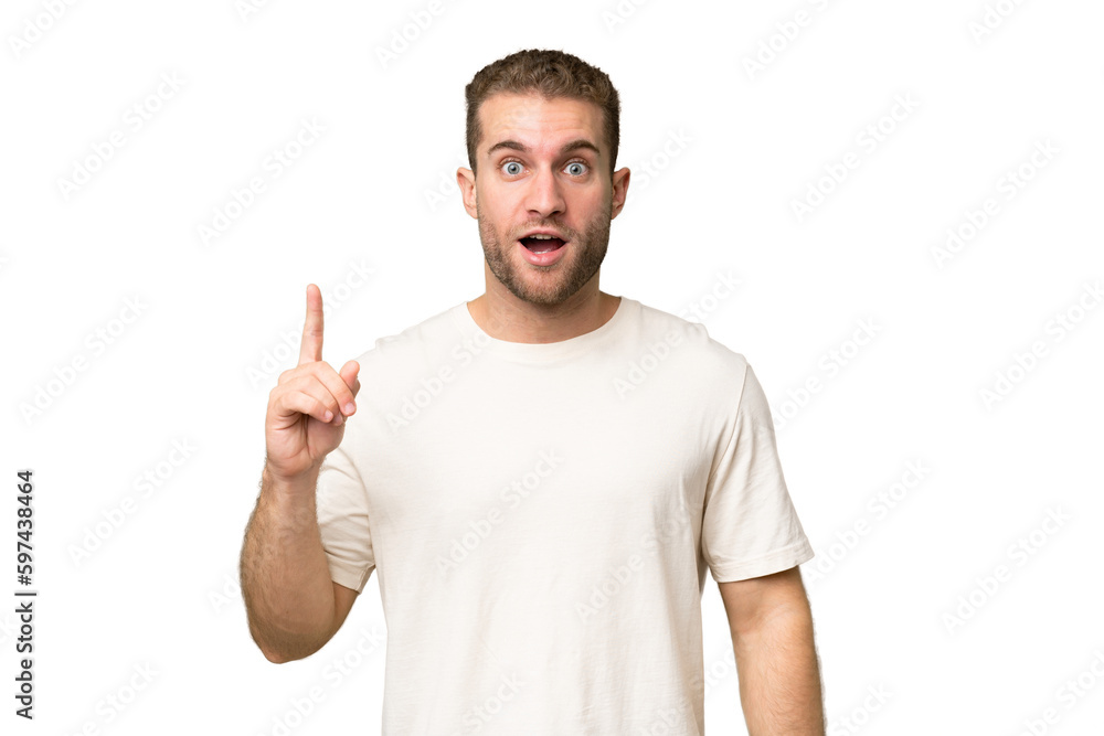 Young handsome caucasian man isolated on green chroma background thinking an idea pointing the finger up Young handsome caucasian man isolated on green chroma background thinking an idea pointing the finger up