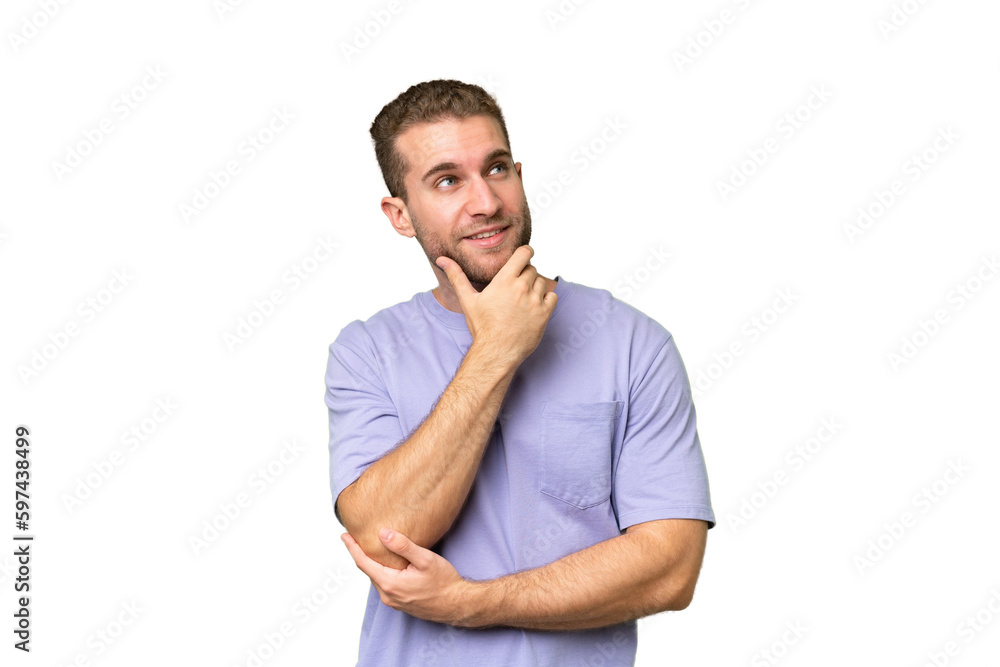 Young handsome caucasian man isolated on green chroma background thinking an idea while looking up Young handsome caucasian man isolated on green chroma background thinking an idea while looking up