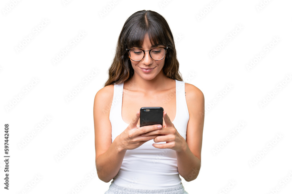 Young caucasian woman over isolated background sending a message or email with the mobile Young caucasian woman over isolated background sending a message or email with the mobile
