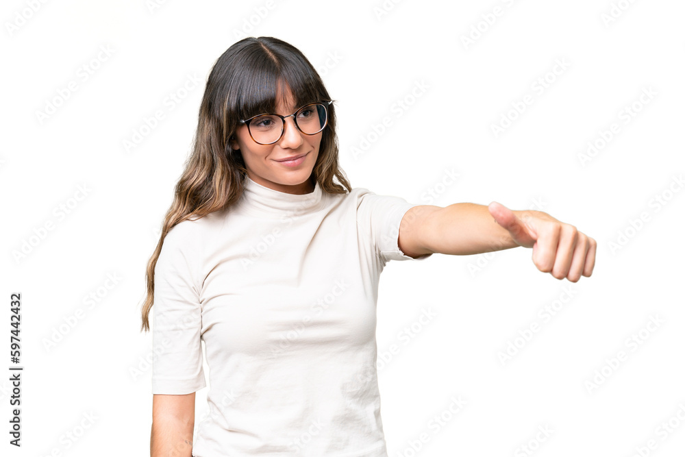 Young caucasian woman over isolated background giving a thumbs up gesture Young caucasian woman over isolated background giving a thumbs up gesture