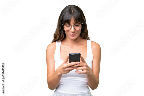 Young caucasian woman over isolated background sending a message or email with the mobile