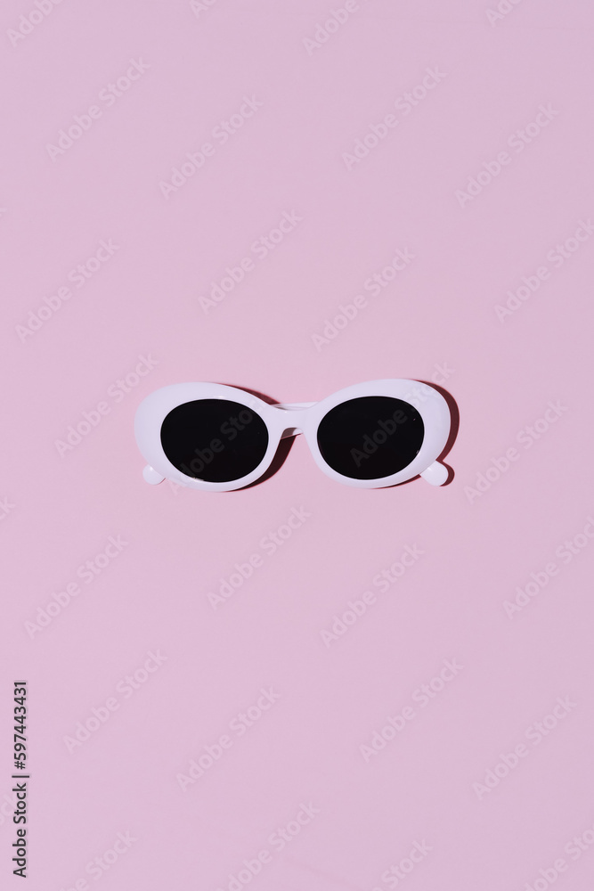 White round glasses on a pink background in a minimalist style. Flat lay, top view. White round glasses on a pink background in a minimalist style. Flat lay, top view.