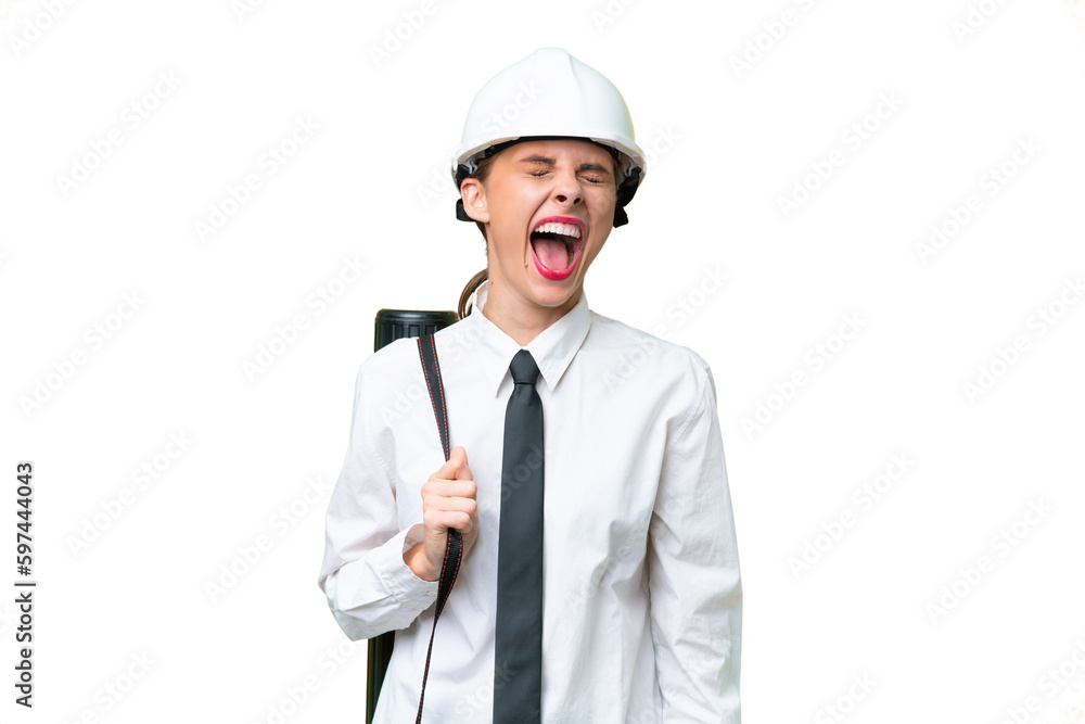 Young architect woman with helmet and holding blueprints over isolated background laughing Young architect woman with helmet and holding blueprints over isolated background laughing