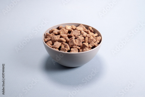 Chocolate corn snacks pads, dry breakfast in a bowl on a gray background