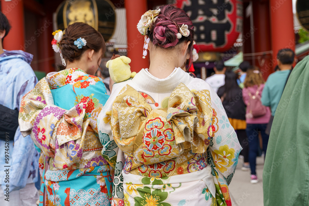 Young girl wearing Japanese kimono standing in front of Sensoji Temple in Tokyo, Japan. Kimono is a Japanese traditional garment. The word 