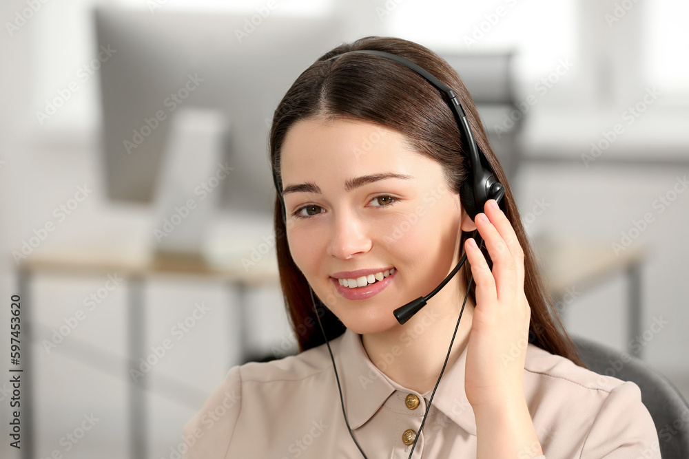 Hotline operator with headset working in office Hotline operator with headset working in office
