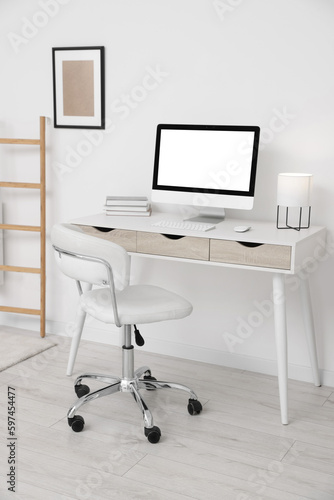 Workplace with comfortable office chair indoors. Interior design © New Africa