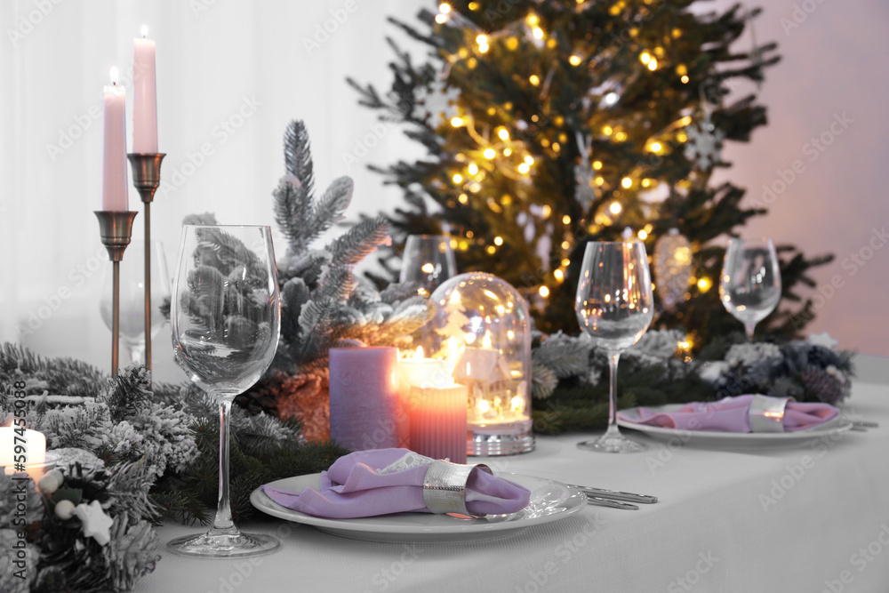 Beautiful festive table setting with Christmas decor in room Beautiful festive table setting with Christmas decor in room