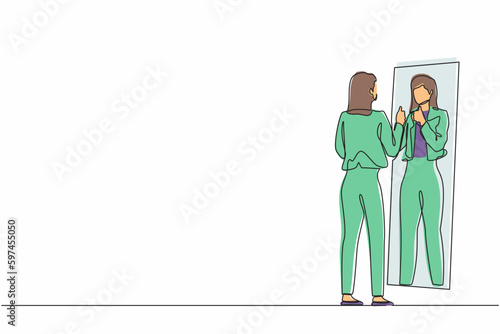 Single continuous line drawing businesswoman loves to look at her reflection in mirror with thumbs up pose. Woman in mirror reflection, egoistic, attractive confidence. One line graphic design vector