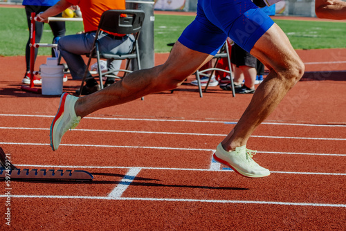 Canvas Print legs male athlete start running in starting blocks sprint race, summer athletics