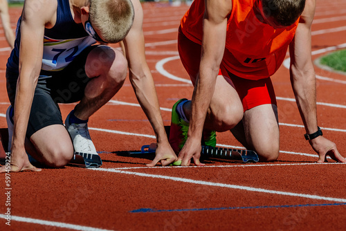 Canvas Print blind para athlete runner with guide in starting blocks ready running race, summ