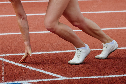 female athlete runner starting position run sprint race red track stadium, summer athletics championships