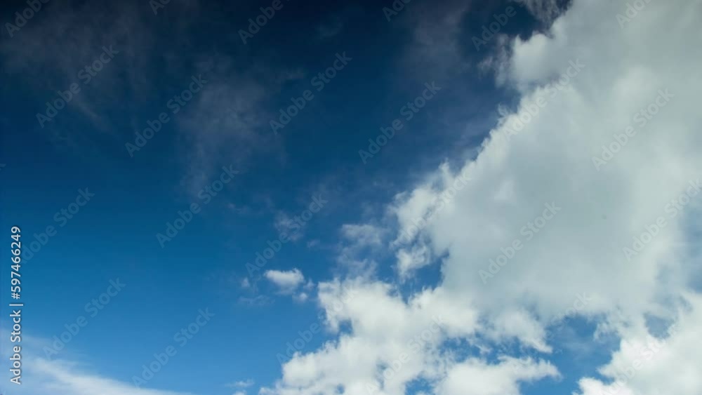 Timelapse white clouds in the blue sky fly in different directions Timelapse white clouds in the blue sky fly in different directions