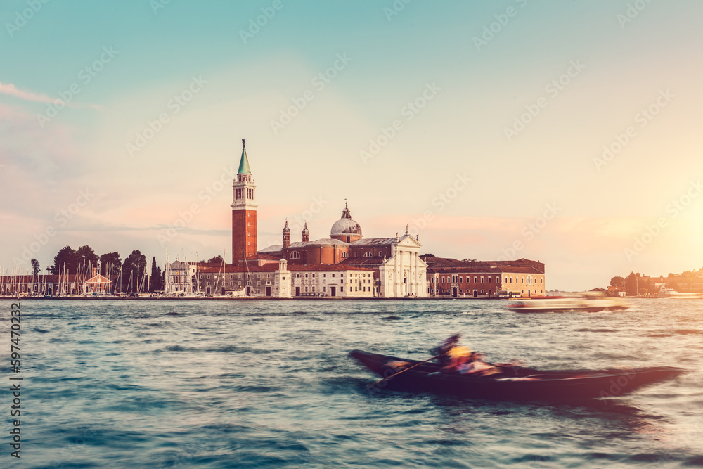 Fototapeta premium Gondola ride in Venice, Italy at sunset.