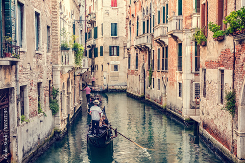 Gondolier rowing gondola on canal in Venice, Italy. © Photocreo Bednarek