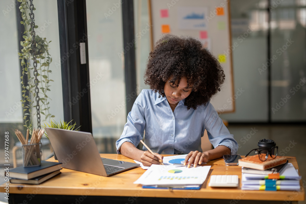 Black woman sitting in front of her considering work, office work Business woman sitting thinking work concept, Write a plan Black woman sitting in front of her considering work, office work Business woman sitting thinking work concept, Write a plan