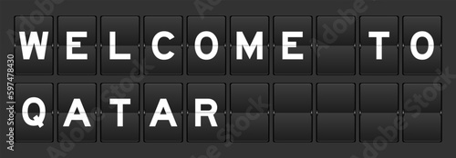 Black color analog flip board with word welcome to qatar on gray background