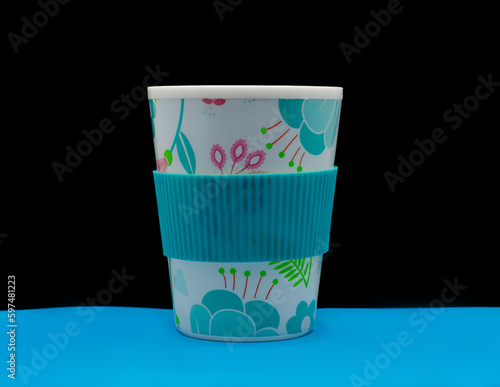 multicolour eco-cup of coffee on black background photo