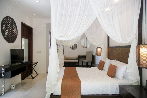 Simple contemporary bedroom with king size bed and mosquito net