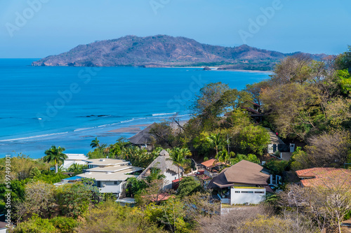 A view along the beach over the resort of Tamarindo towards the bay in Costa Rica in the dry season
