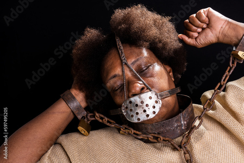 Portrait of a black woman in chains with an iron mask on her face representing the slave Anastacia. Slavery in Brazil.
