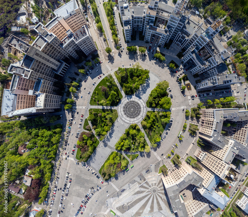 Aerial look down panorama view on Freedom Svobody Square fountain circle with spring green park, Derzhprom and Karazin university buildings. Kharkiv, Ukraine