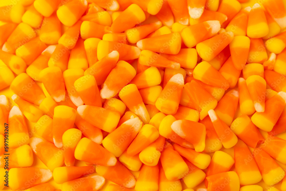 Halloween candy corn on texture background.Classic white, orange and yellow candy corn sweets for Halloween with.copy space.Halloween holiday concept with candy corn and jack o lantern.copy space Halloween candy corn on texture background.Classic white, orange and yellow candy corn sweets for Halloween with.copy space.Halloween holiday concept with candy corn and jack o lantern.copy space